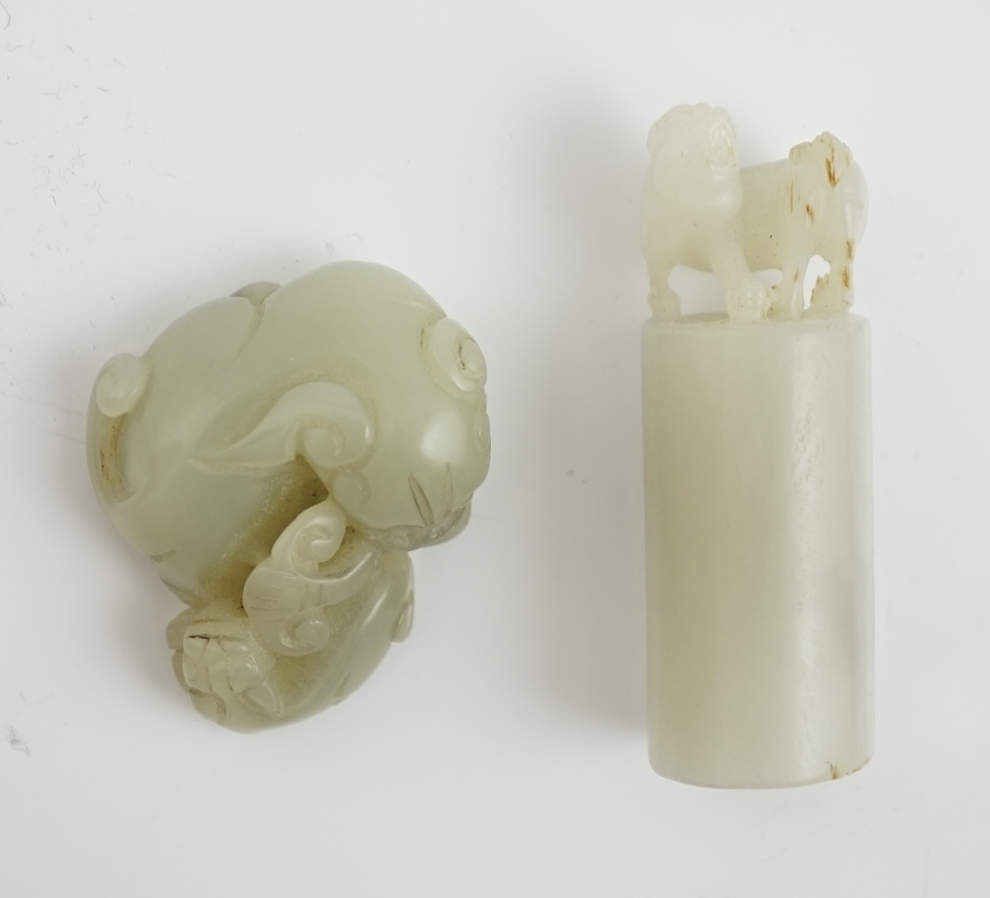 A Chinese white jade lion-dog seal and a Chinese pale celadon jade group of a lion dog and cub, 19th century